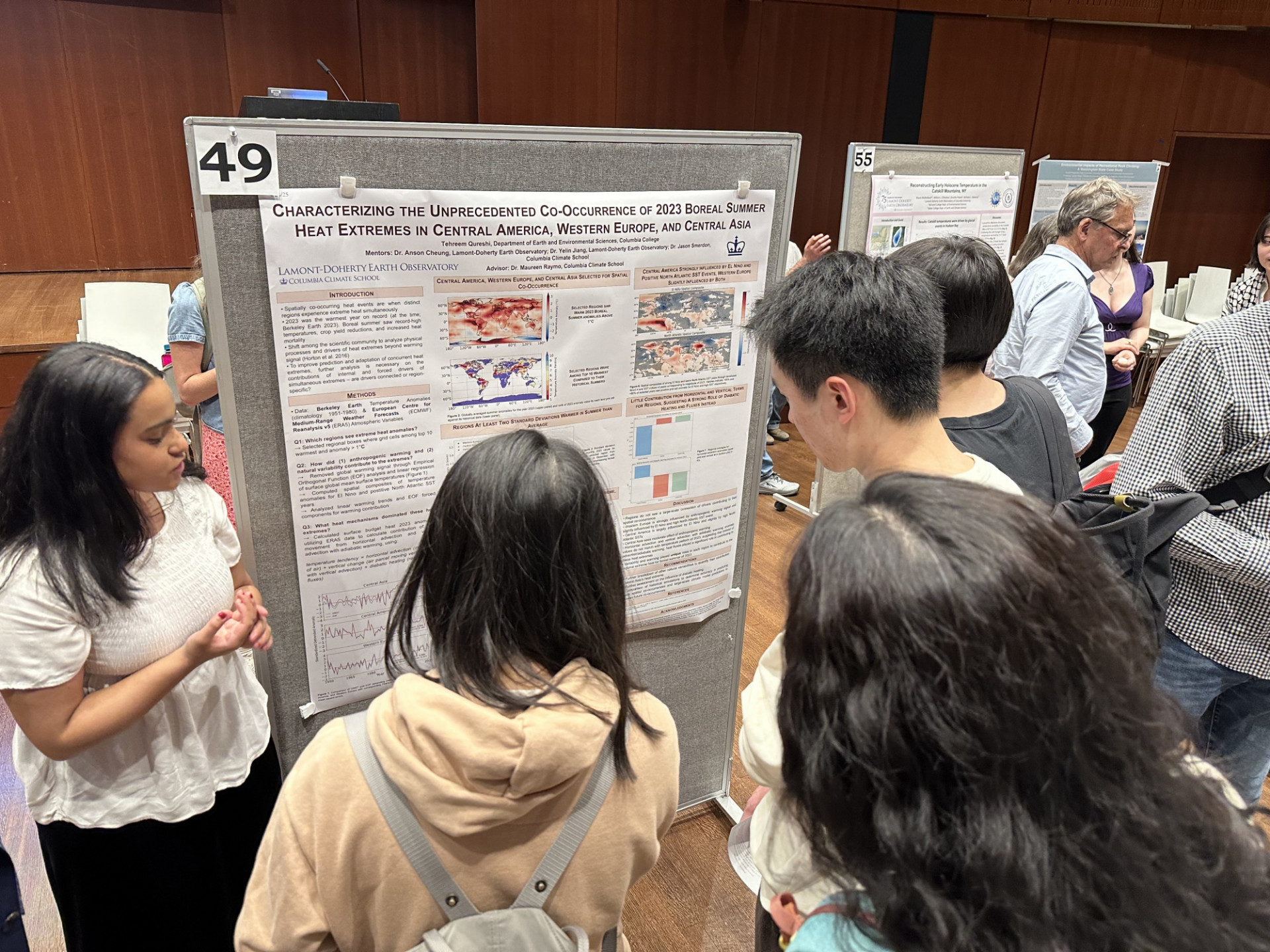 Tehreem presents in front of her poster.